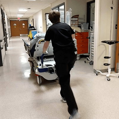 gurney-being-pushed-down-hallway