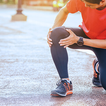 Person knelt down and holding their knee